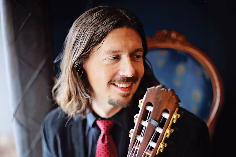 a man poses with his guitar