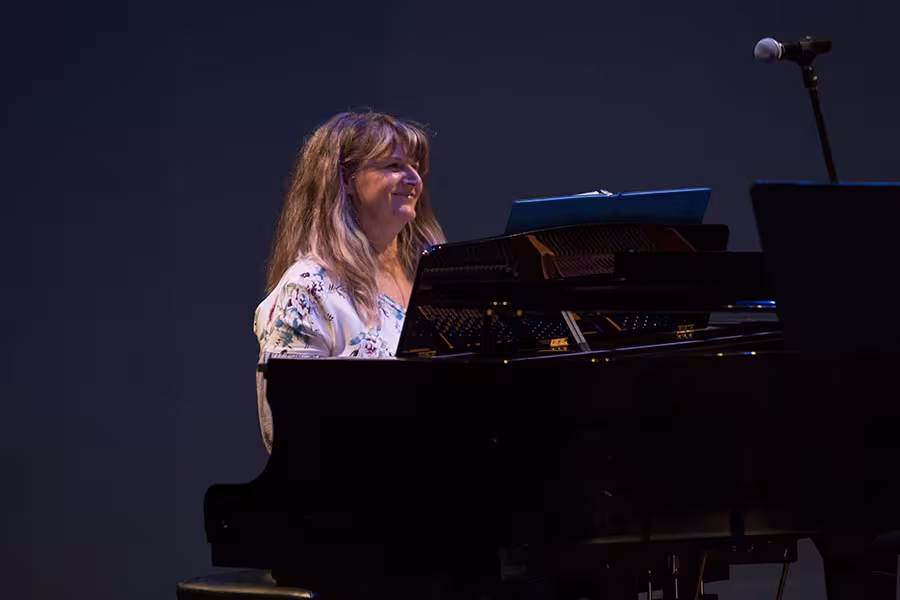 Mindy Rohn accompanies an alumni performer during David Montee and Robin Ellis’ 2018 retirement celebration.