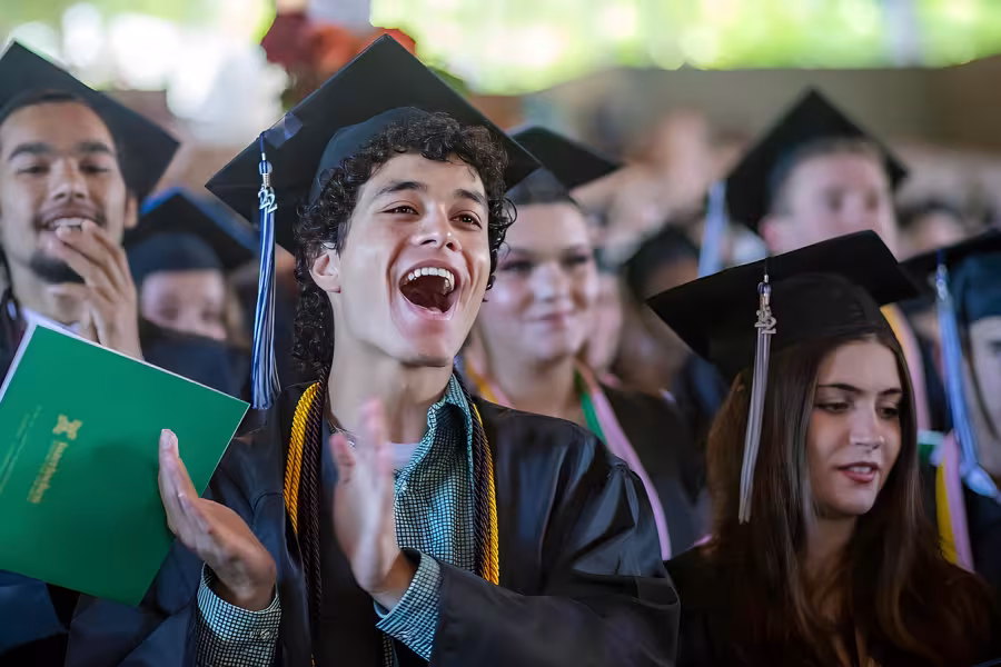 Interlochen Arts Academy students clap during graduation