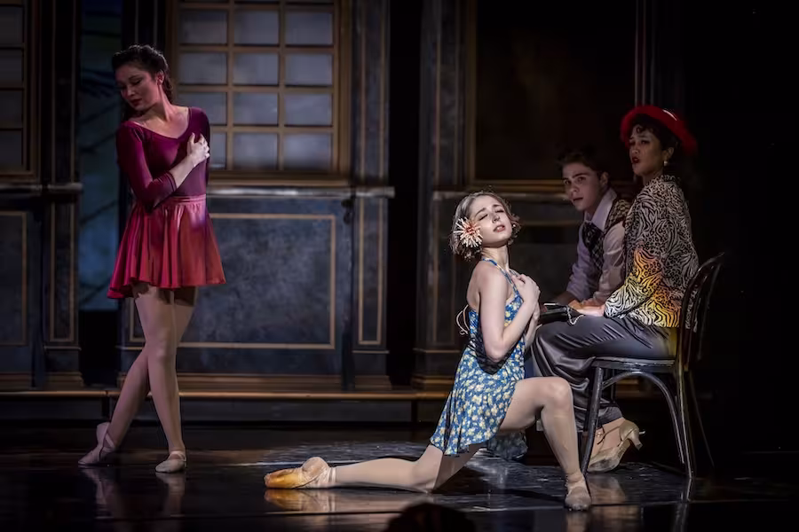 Scene where two young women are dancing with 2 onlookers