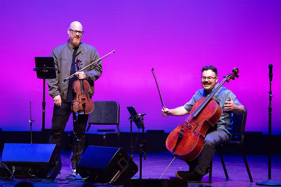 Vitamin String Quartet members Thomas Lea, viola, and Derek Stein, cello, chat with students during a master class in Corson Auditorium.