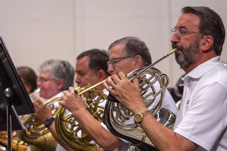 People playing horn in an ensemble