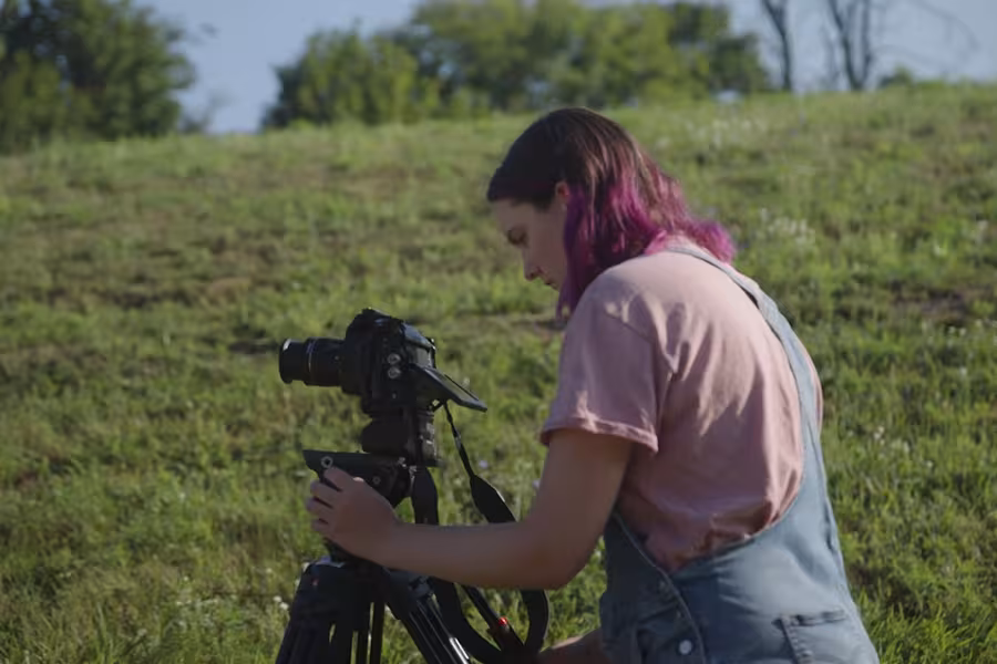 A film student operates a camera at a Grow Benzie event