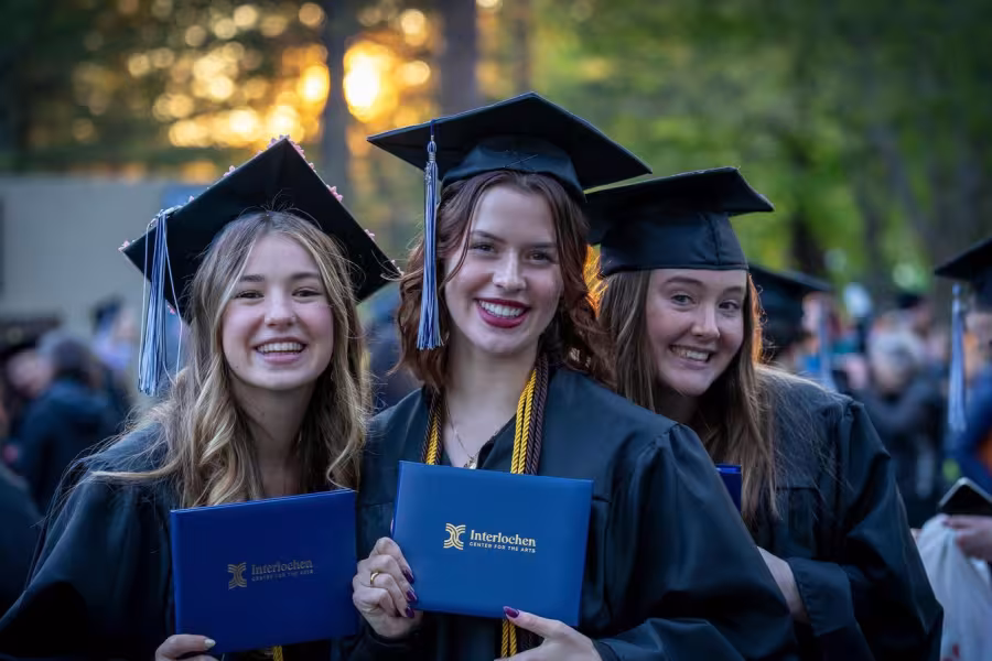 Interlochen Arts Academy students smile with their diplomas