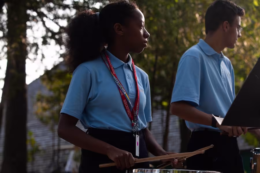 Camper Playing Drums Outside