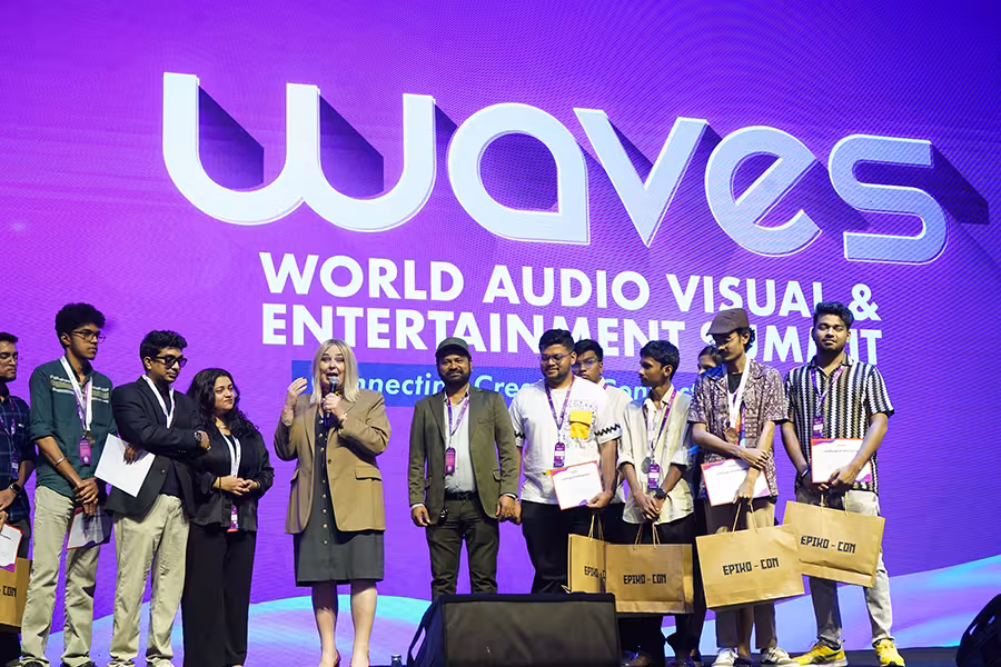 Briana Yarhouse (fourth from left, tan blazer) on the stage at a WAVES event.