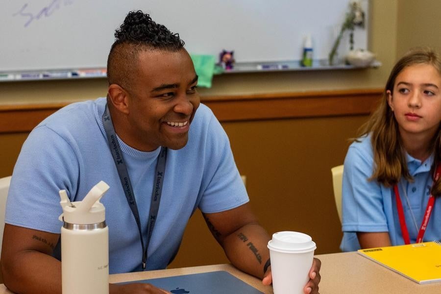 An Interlochen Arts Camp creative writing faculty member works with students. 