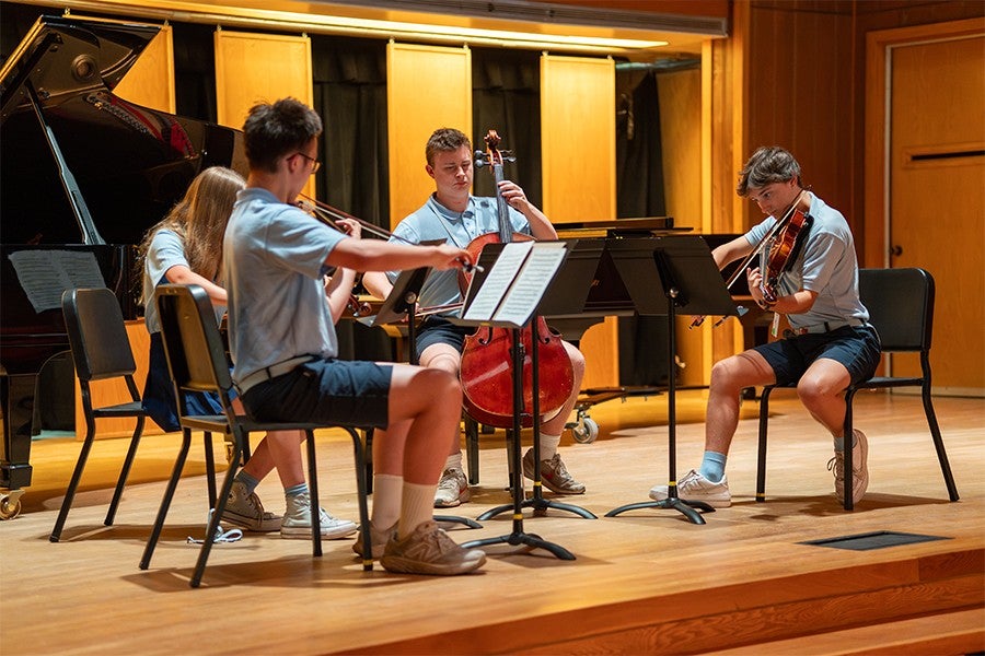A student string quartet rehearses in Dendrinos Chapel & Recital Hall. 