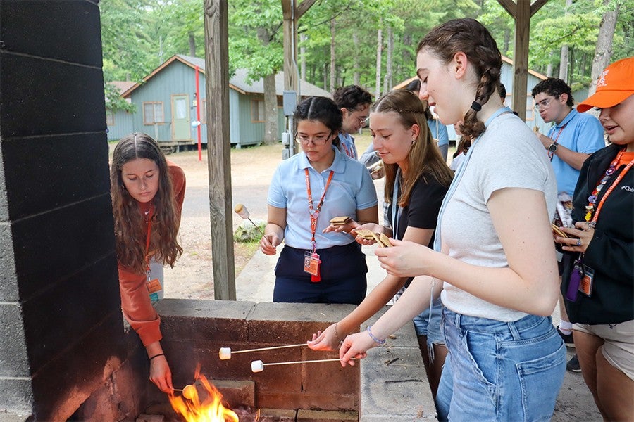 High School Bluffs residents roast marshmallows for s’mores on the Sundecker. 