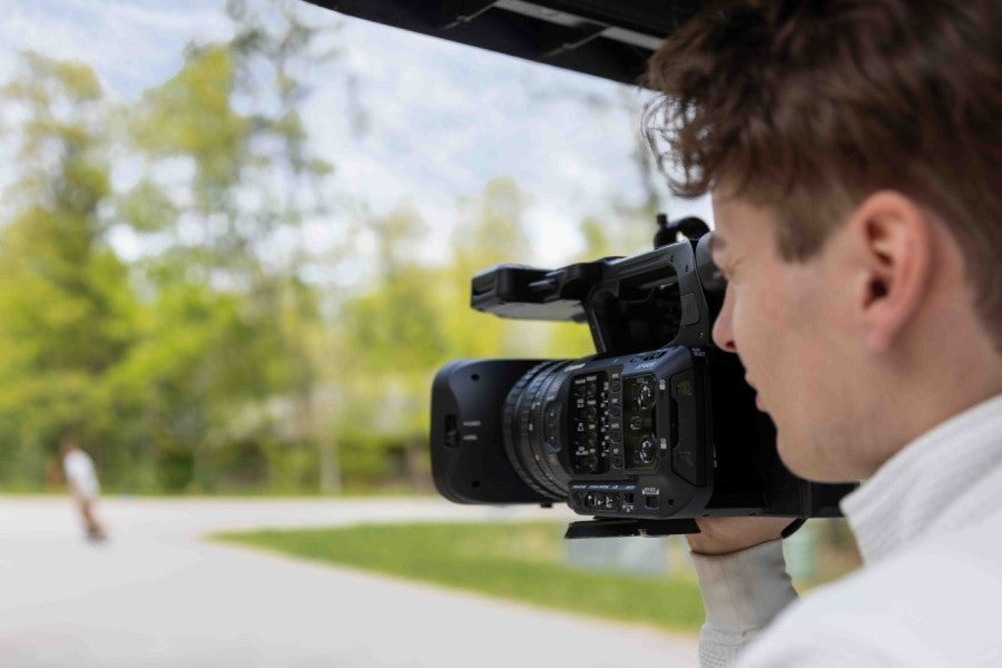 Man holding a camera and filming