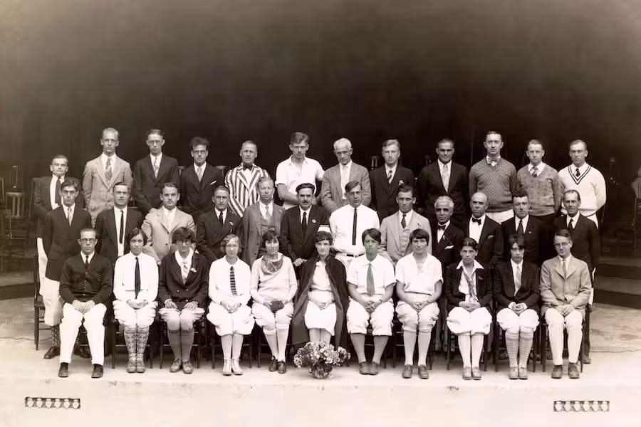 Black-and-white group photo of thirty-five faculty and staff  in formal or semi-formal attire, arranged in three rows.