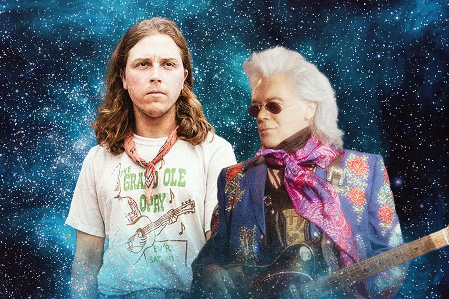 Two country musicians posed against a cosmic, star-filled background. One musician with long brown hair wears a vintage Grand Ole Opry T-shirt and looks forward. The other musician with styled white hair and sunglasses wears a colorful embroidered jacket and scarf while holding an electric guitar. The image blends classic country style with a surreal, outer-space theme.