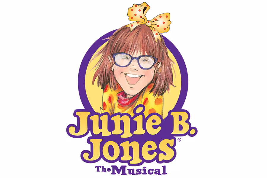 Logo for Junie B. Jones The Musical featuring a smiling illustrated young girl with short brown hair, large blue glasses, and a yellow bow with red polka dots. She appears inside a purple oval frame with a yellow background. Below her, bold yellow and purple text reads “Junie B. Jones,” with smaller purple text underneath reading “The Musical.”