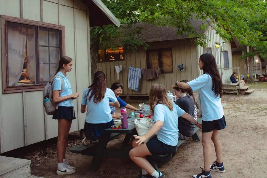 Girls socialize outside their cabin at Interlochen Arts Camp