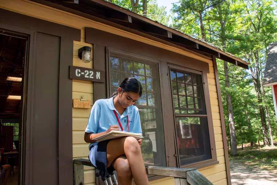 A Drawing and Painting student works on a sketch outdoors. 