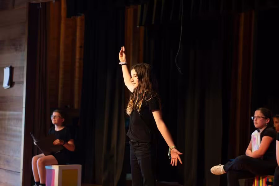 An actor in the Young Actors workshop performs on stage