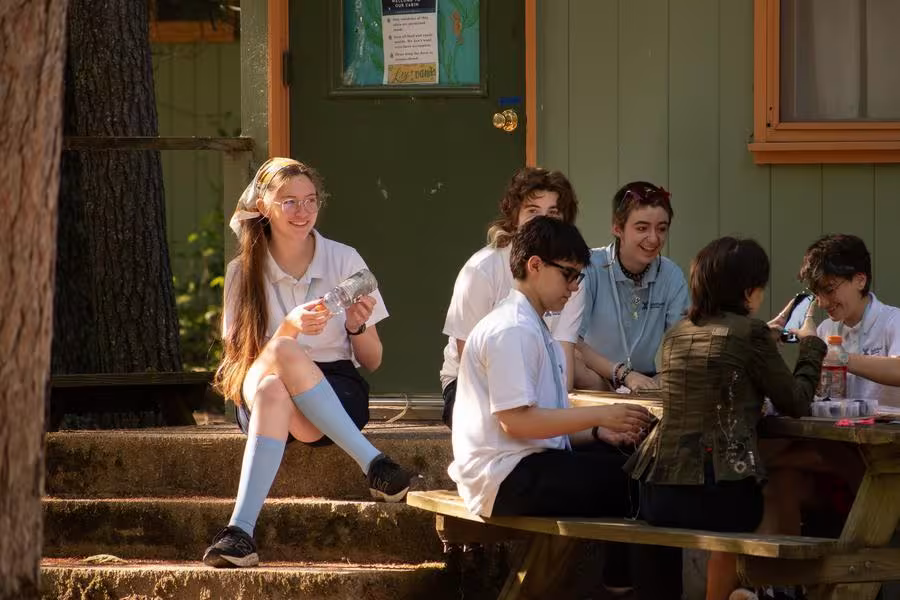 High schoolers make friendship bracelets during Opening Weekend.