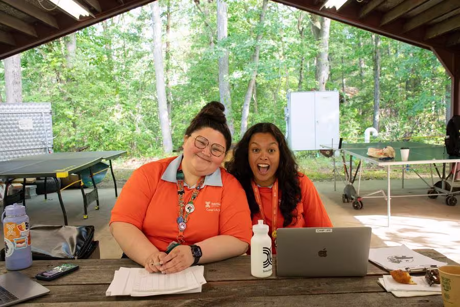 Two Camp counselors prepare to welcome students to Intensives week. 