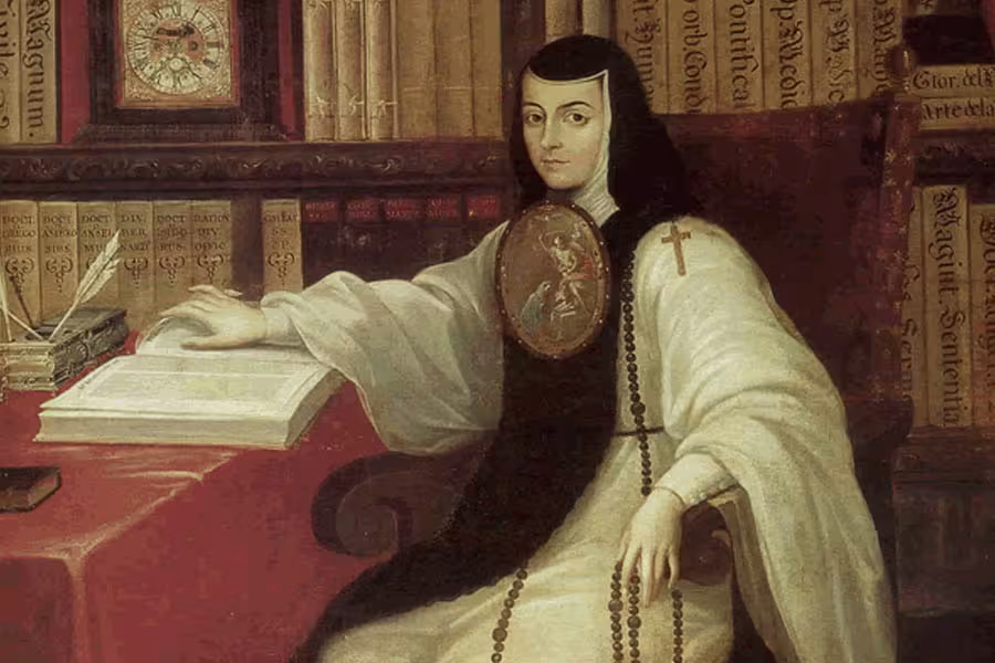 An 18th-century portrait depicts Sor Juana Inés de la Cruz seated at a writing desk in a library lined with books. Dressed in a white nun's habit with a black veil, she rests one hand on an open book while looking toward the viewer. A quill, books, clock, rosary, and medallion emphasize her life as a scholar, writer, and religious figure.