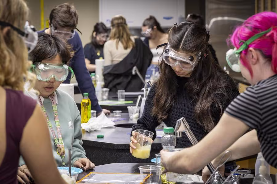A group of students run a chemistry experiment 