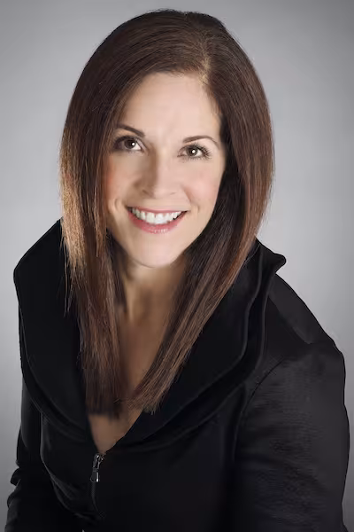 Camp and Academy parent Carolyn Caputo-McCauley wearing a black top and smiling