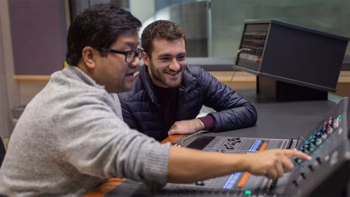 A teacher and student work with a digital audio interface