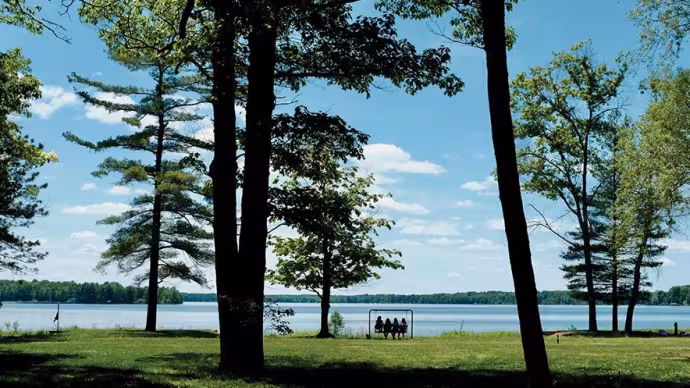 Intermediate girls sit on a swing near Green Lake