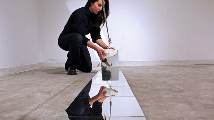 A visual artist sets up an installation