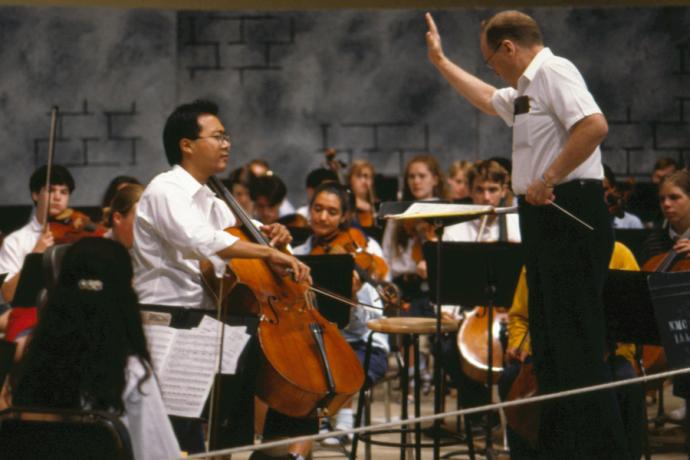 Henry Charles Smith III conducts Interlochen’s World Youth Symphony Orchestra with guest Yo-Yo Ma in 1995.