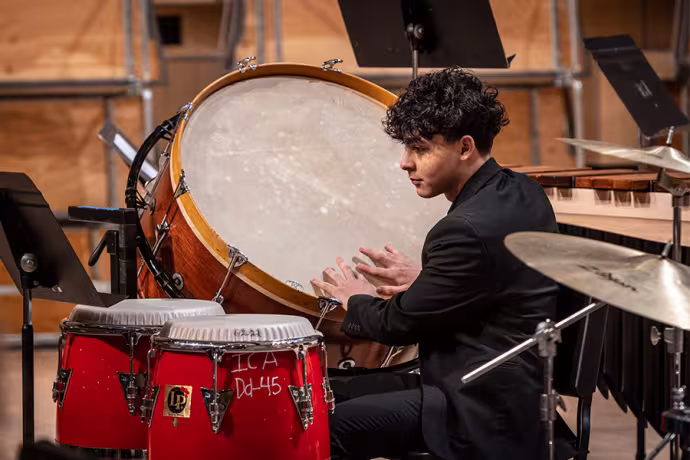 An Interlochen Arts Academy percussion student plays a bass drum