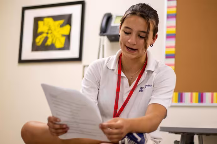A student reads aloud a new composition in a Creative Writing class.