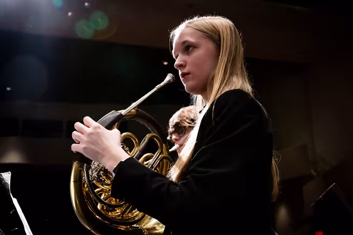 Arts Academy horn student Sydney Richardson rehearses with the IAA Wind Symphony