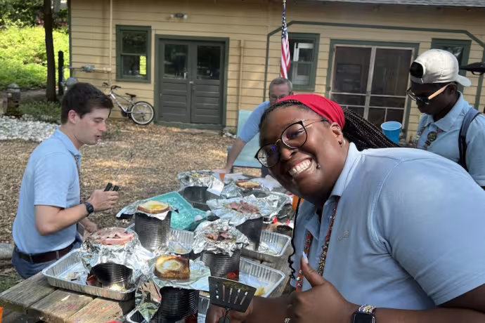 Jessi Woods smiles as she helps cook a Camp meal.
