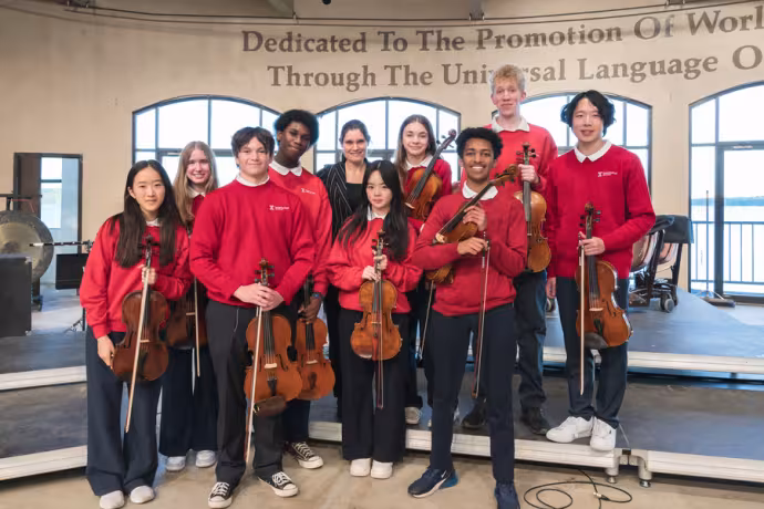 Interlochen Arts Camp students smile with guest conductor
