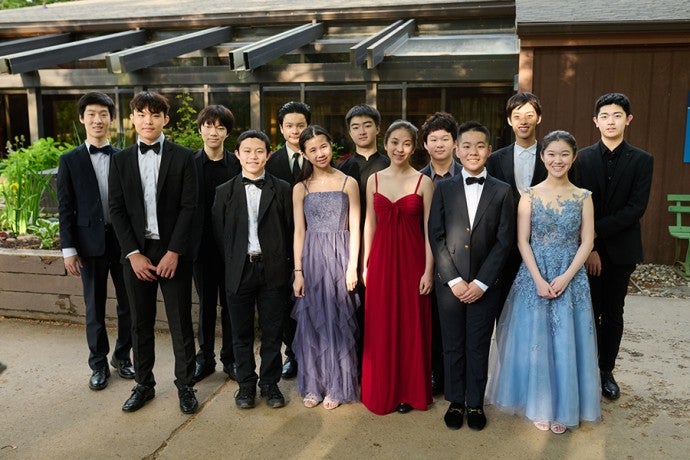 The Lang Lang Young Scholars pose in front of Interlochen’s Dendrinos Chapel and Recital Hall before their end-of-session concert. 