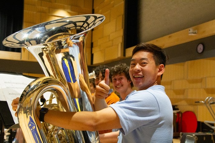 Interlochen Arts Camp students smile for the camera during a pause in rehearsal.