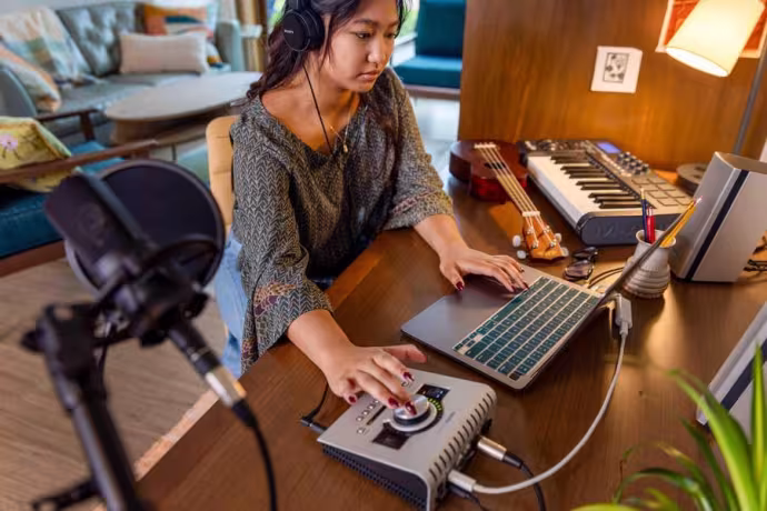 A student works on a computer with a Digital Audio Workstation.
