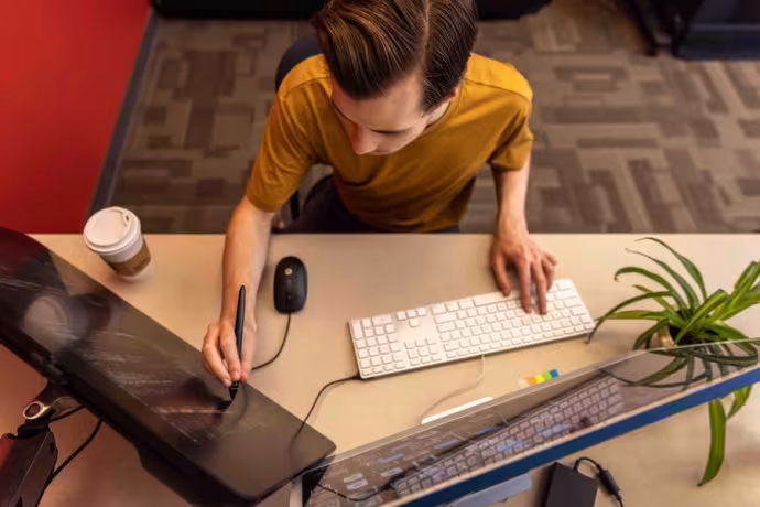 A student focuses intently at a computer.