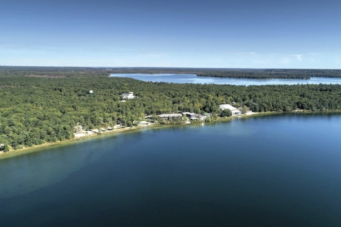 Aerial shot of Interlochen's campus showing the two lakes and pine forests