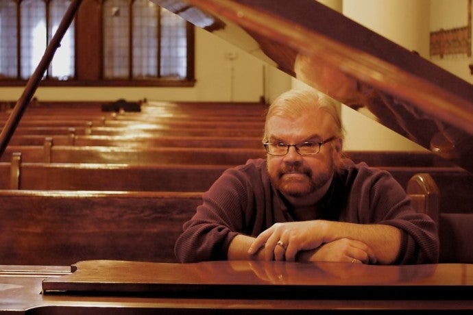 James Carter Cathcart sits at the piano.