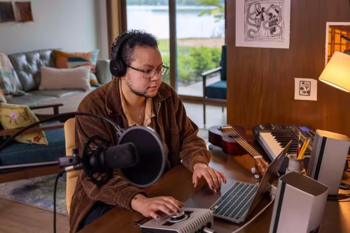 A student works at a laptop in a home environment.