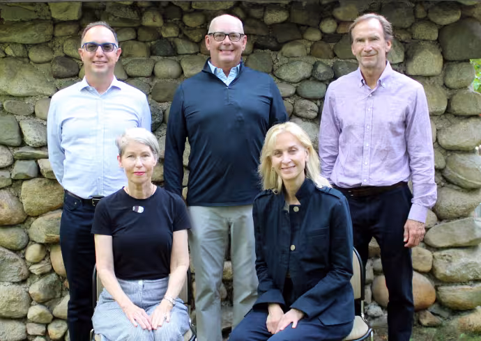 The 2026 board of trustees pose for a photo in front of a stone wall. Standing in the back row is Ozzy Oguz, Chris Sogard, David Inglish. Standing in the front row is Paula Jo Kemler, Lisa Laplace.