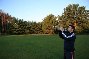 A trumpeter plays morning bugle calls