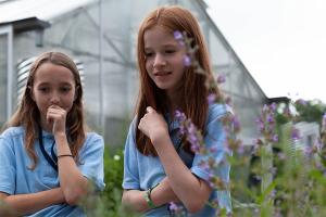Campers attend a pollinators class at the greenhouse