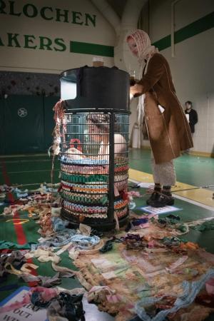 An interactive performance piece by Marlene Schwier (in trash can) designed to help the audience reconnect with their possessions.