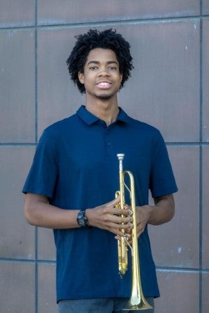 Tim Abrams poses with a trumpet.