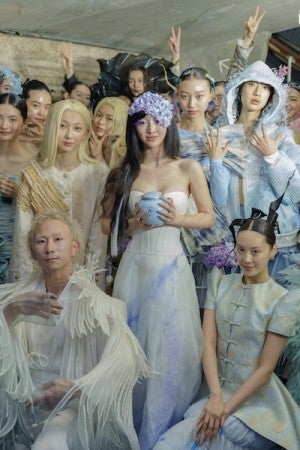 Shao (center) poses with models dressed in designs from her collection.