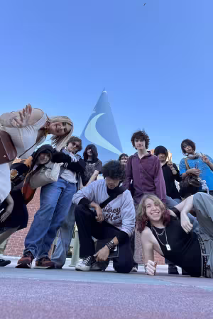 A group of students and an instructor pose in front of Walt Disney Animation Studio's iconic blue tower.