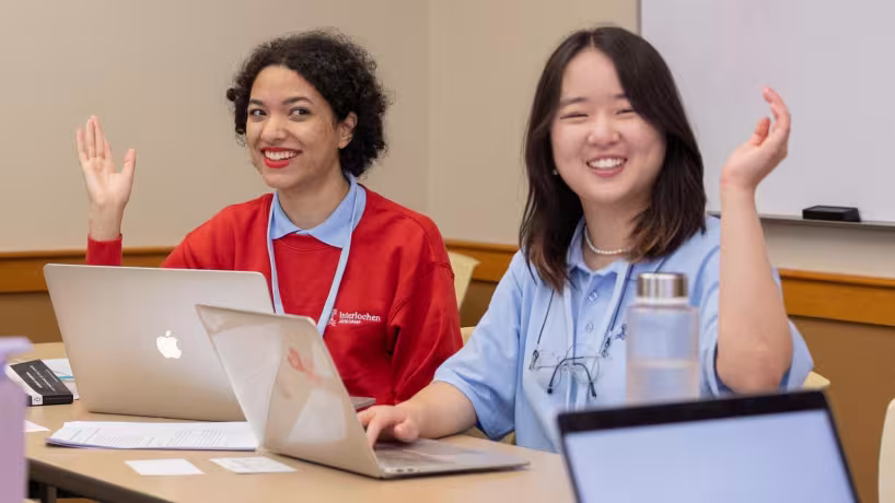 Creative Writing camp student sits outside and writes