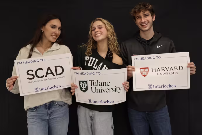 Three Interlochen Arts Academy students showing where they will be going to college